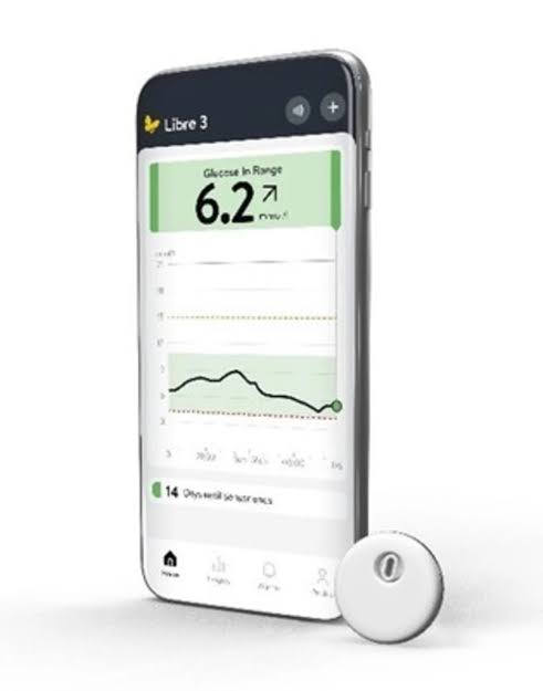 FreeStyle Libre 3 sensor and Libre app glucose reading on a phone