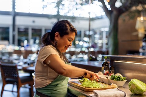 A chef in their kitchen, Dexcom G7 sensor visible on the upper arm